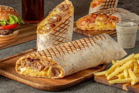The French taco, which bears little resemblance to anything Mexican, is a cross between a grilled panini, wrap and kebab, with everything sealed inside a vast rectangular parcel – fries included.